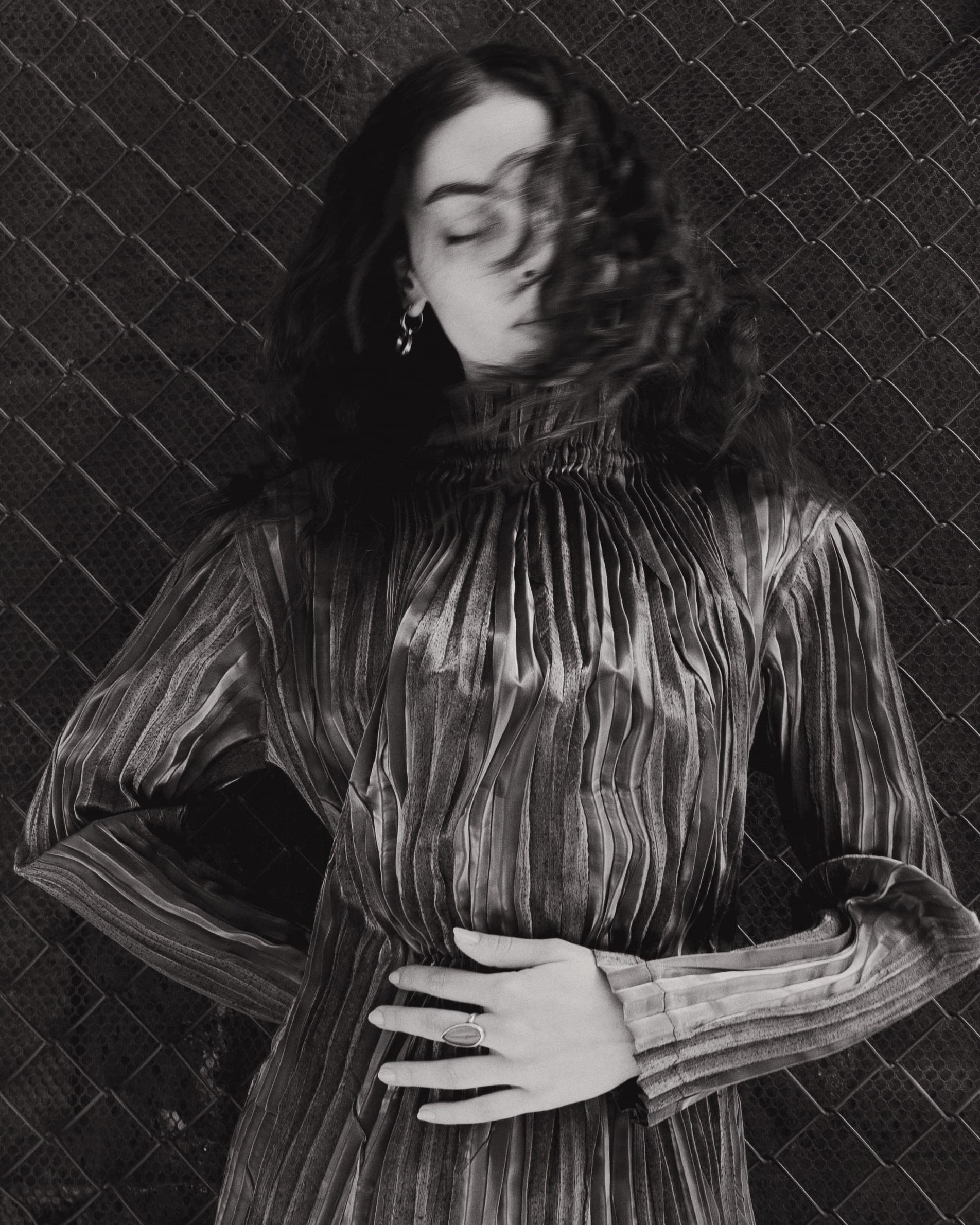 A model wearing an archival silver pleated Issey Miyake dress